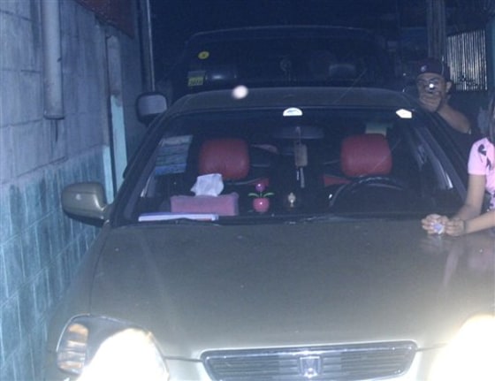 In this handout photo provided by the Dagsa family, an alleged assassin aims a gun at Reynaldo Dagsa, who was taking a picture of his family on New Year's Day.